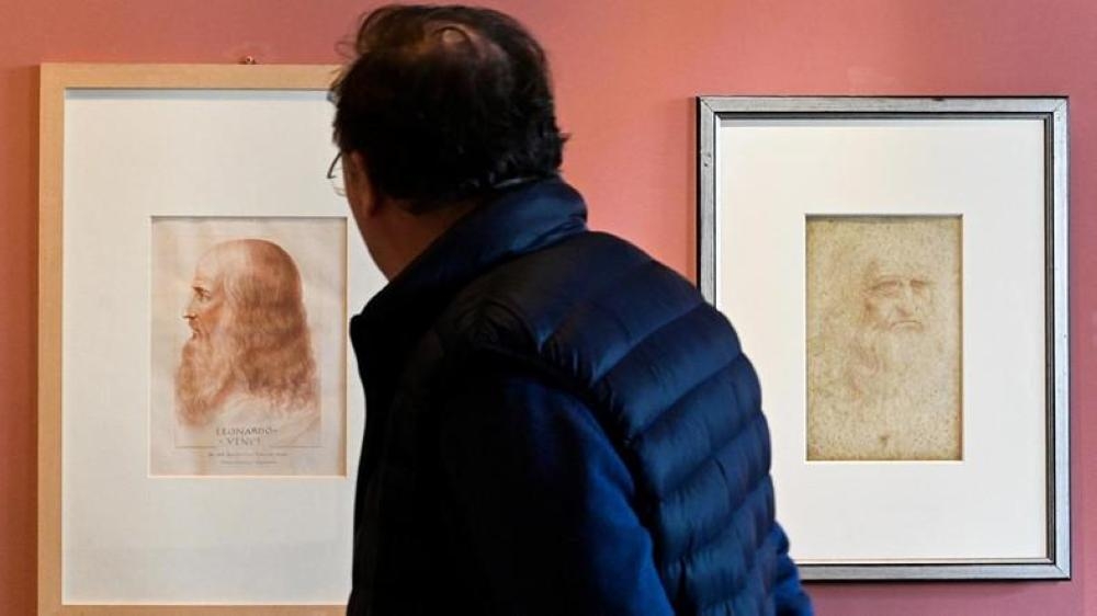 A portrait of Leonardo Da Vinci by Francesco Melzi (L) and a Da Vinci self-portrait (R) at the Leonardo Da Vinci museum during an exhibition marking the 500th anniversary of the death of Renaissance artist, on May 2, 2019 in Vinci, Tuscany. — AFP
