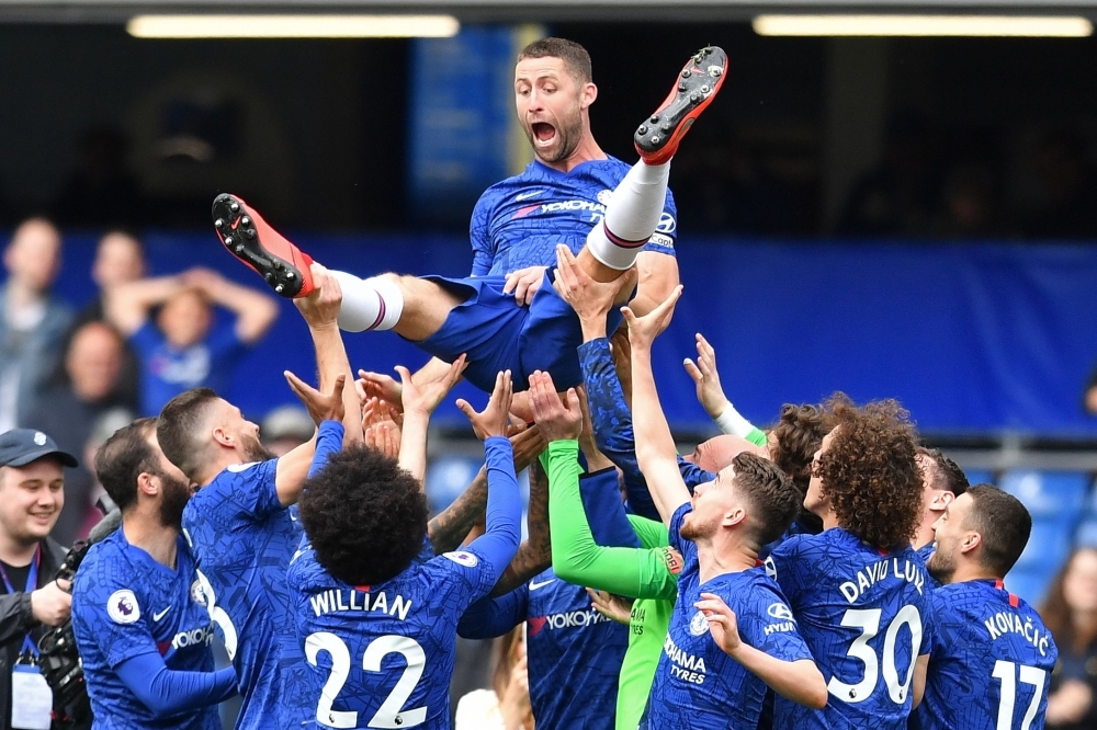 Chelsea's English defender Gary Cahill reacts as teammates throw him in the air following the English Premier League football match against Watford at Stamford Bridge in London on Sunday. Chelsea won the match 3-0. — AFP