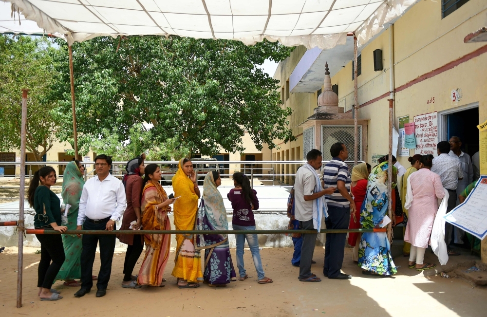 Indian voters queue at a polling station to cast their vote during the fifth phase of India’s general election in Dausa in the northern Indian state of Rajasthan on Monday. — AFP