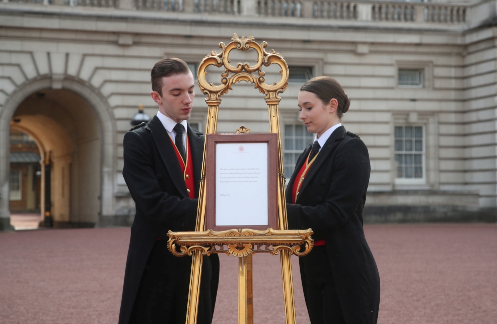 Footmen Stephen Kelly and Sarah Thompson bring out the easel in the forecourt of Buckingham Palace to formally announce the birth of a baby boy to Britain's Prince Harry and Meghan, Duchess of Sussex in London. — Reuters