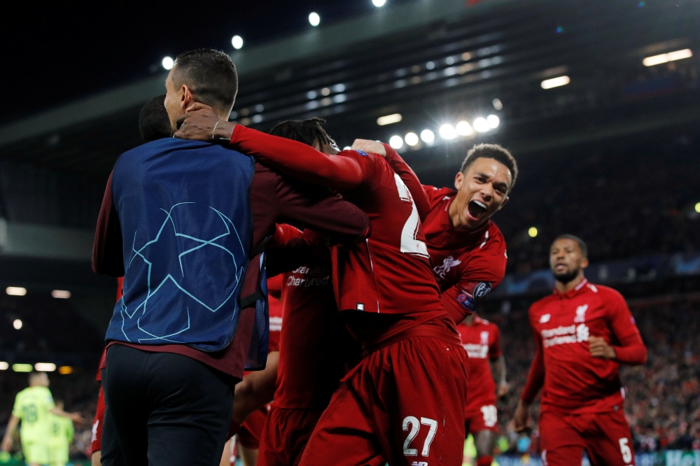 Liverpool's Divock Origi celebrates scoring their fourth goal with Trent Alexander-Arnold and teammates during the Champions League semifinal second leg match against Barcelona at the Anfield, Liverpool, Britain, on Tuesday. — Reuters