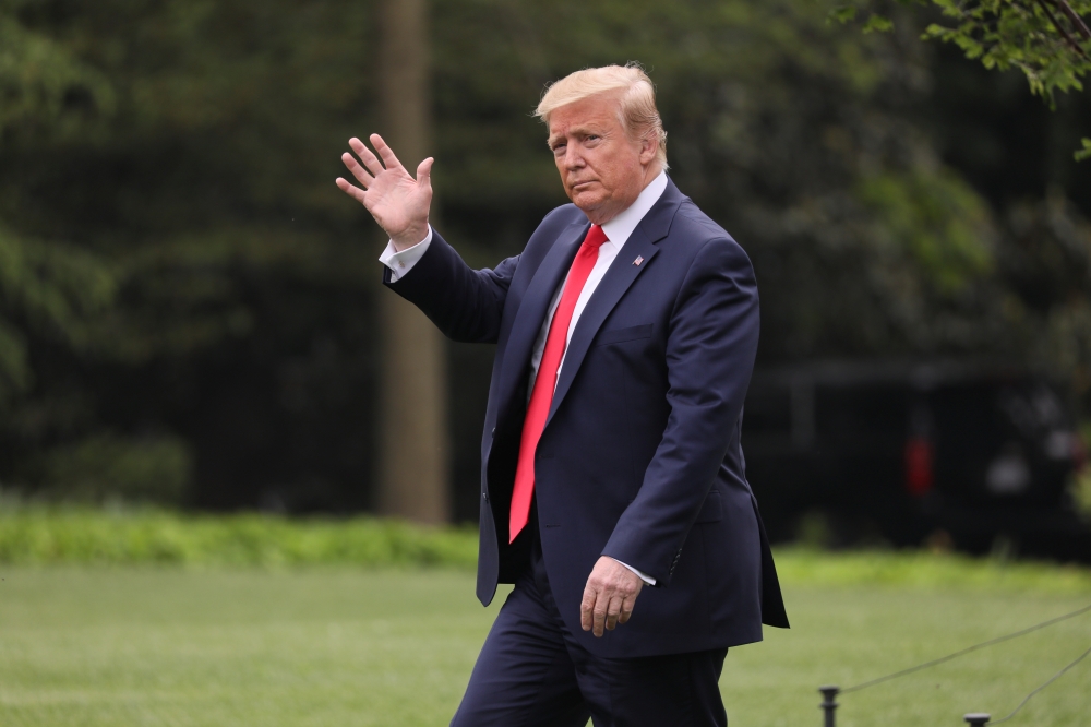 US President Donald Trump waves as he departs for travel to Florida from the White House in Washington on Wednesday. — Reuters