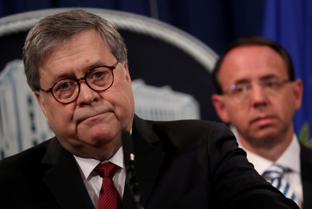 US Attorney General William Barr, flanked by Deputy US Attorney General Rod Rosenstein, speaks at a news conference to discuss Special Counsel Robert Muellerís report on Russian interference in the 2016 US presidential race, in Washington, in this April 18, 2019 file photo. — Reuters