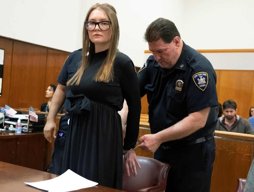 Anna Sorokin, who a New York jury convicted last month of swindling more than $200,000 from banks and people, is handcuffed during her sentencing at Manhattan State Supreme Court in New York on Thursday. — Reuters