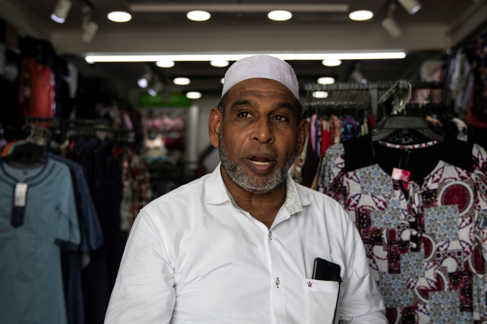 Mohamed Kaleel, the vice-president of the Batticaloa Traders Association, speaks during an interview inside his shop in Batticalao. — Reuters