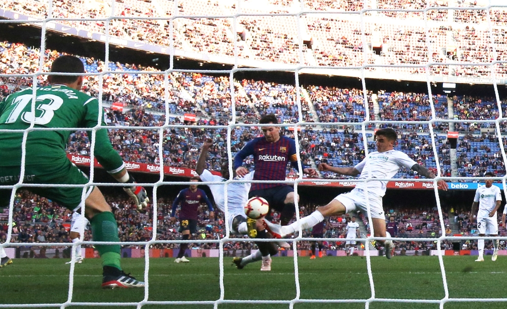 Barcelona's Lionel Messi scores their second goal against Getafe in in the La Liga match at the Camp Nou, Barcelona, Spain, on Sunday. — Reuters
