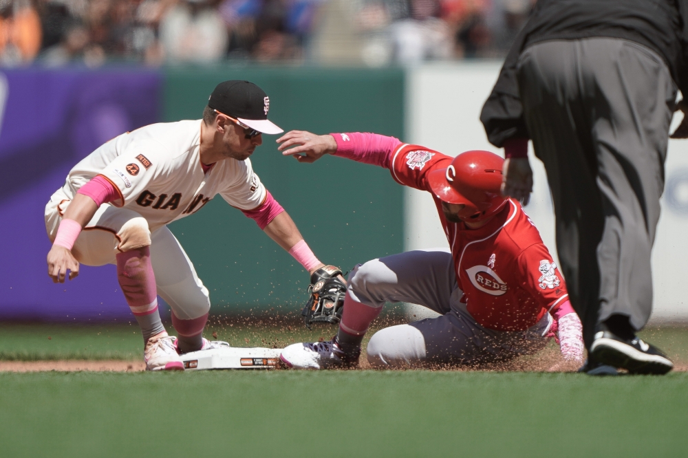 San Francisco Giants second baseman Joe Panik (12) tags out Cincinnati Reds second baseman Jose Peraza (9) during the seventh inning at Oracle Park. — Reuters