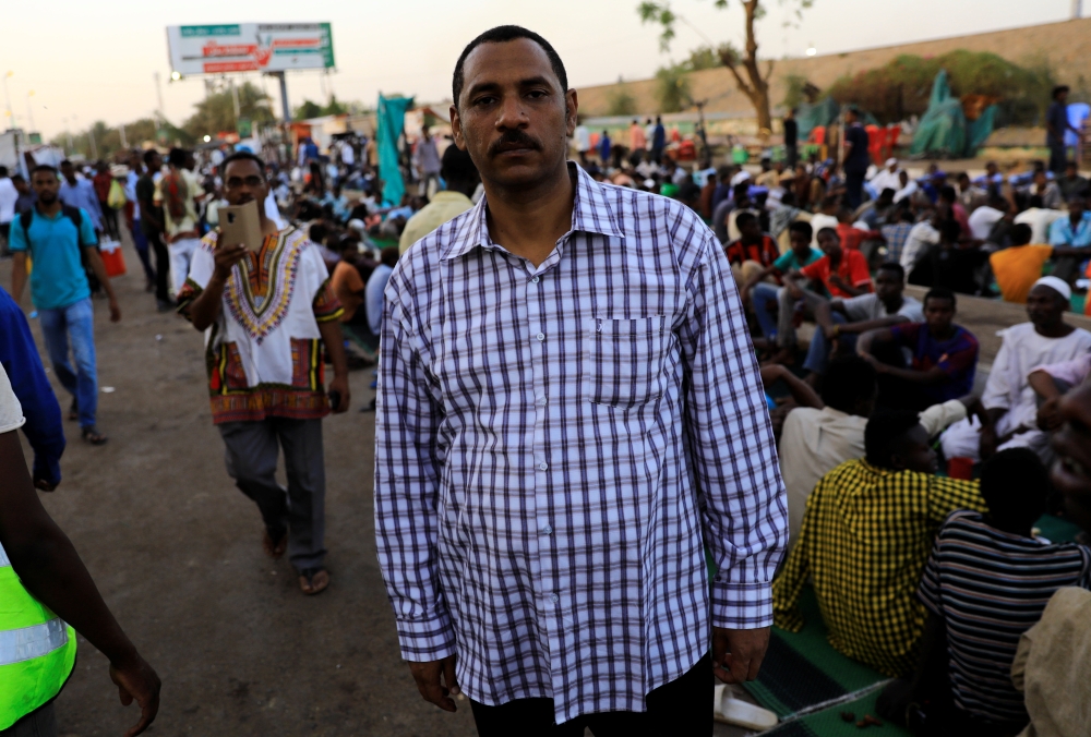 Ahmed Rabie, a member of the Sudanese Professionals Association (SPA), poses as he arrives to break his fast with his friends during the Muslim fasting month of Ramadan in front of the Defence Ministry compound in Khartoum. — Reuters