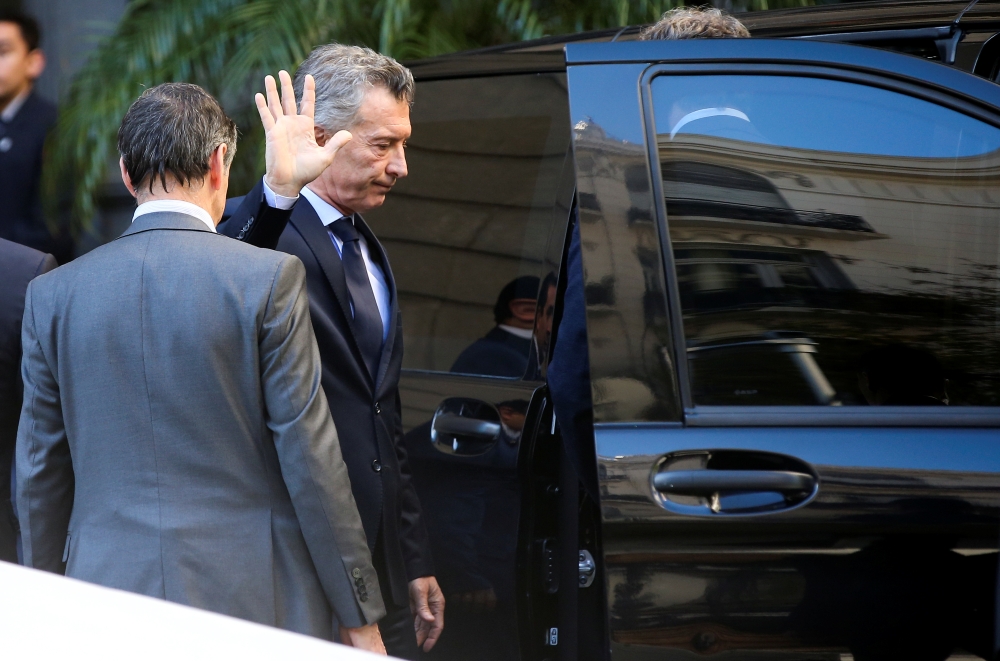 Argentina’s President, Mauricio Macri, waves to the press after attending the wake of lawmaker Hector Olivares, inside the National Congress in Buenos Aires, Argentina, on Monday. — Reuters