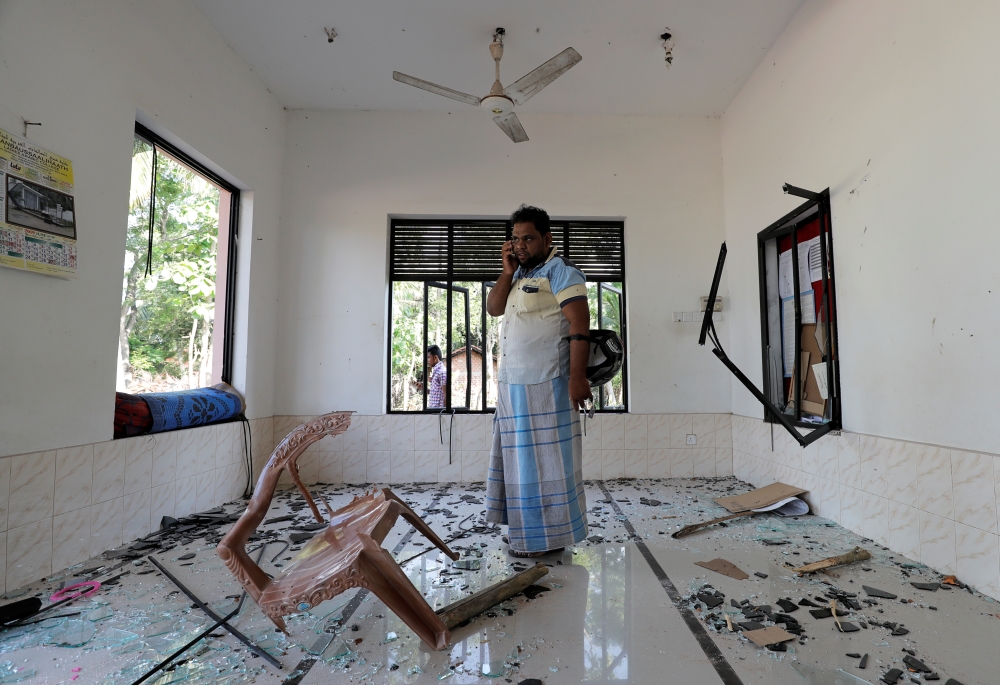 A Muslim man stands inside the Abbraar Masjid mosque on Monday after a mob attack in Kiniyama, Sri Lanka. — Reuters