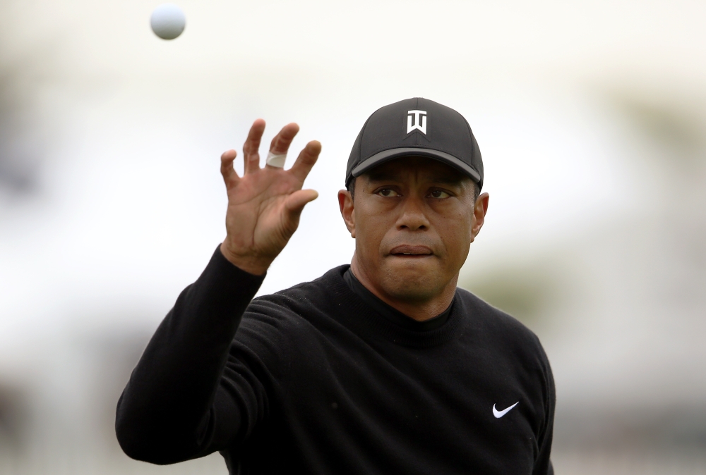 Tiger Woods catches a ball as he practices on the driving range for the PGA Championship golf tournament at Bethpage State Park - Black Course, in Farmingdale, NY, USA. — Reuters
