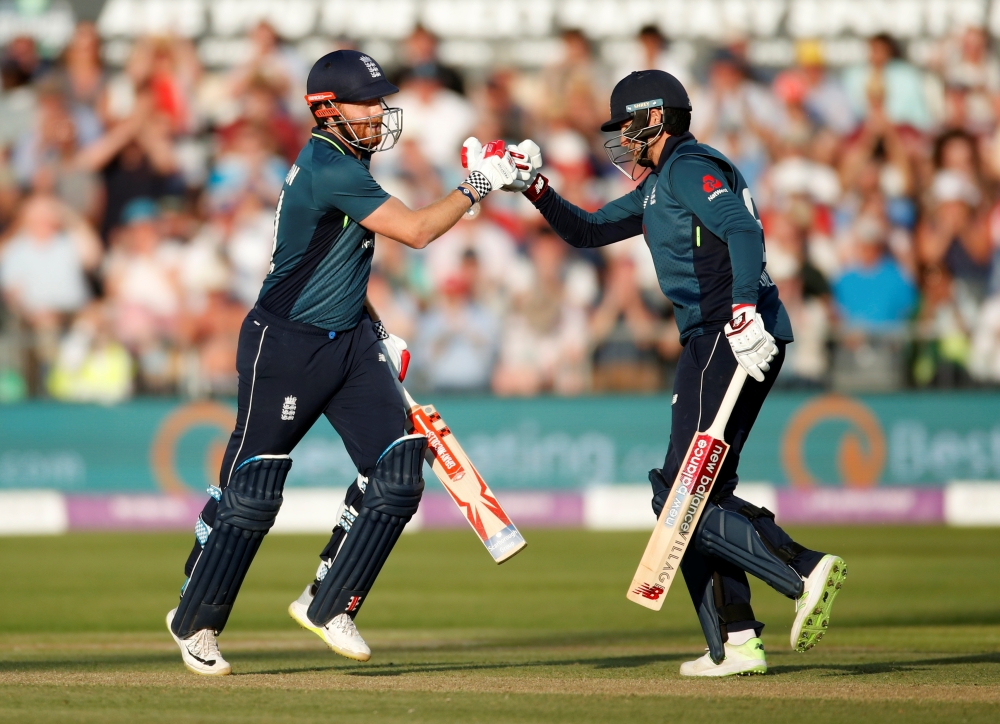 England's Jonny Bairstow celebrates his century with Joe Root during the Third One Day International against Pakistan at the Bristol County Ground, Bristol, Britain, on Tuesday. — Reuters