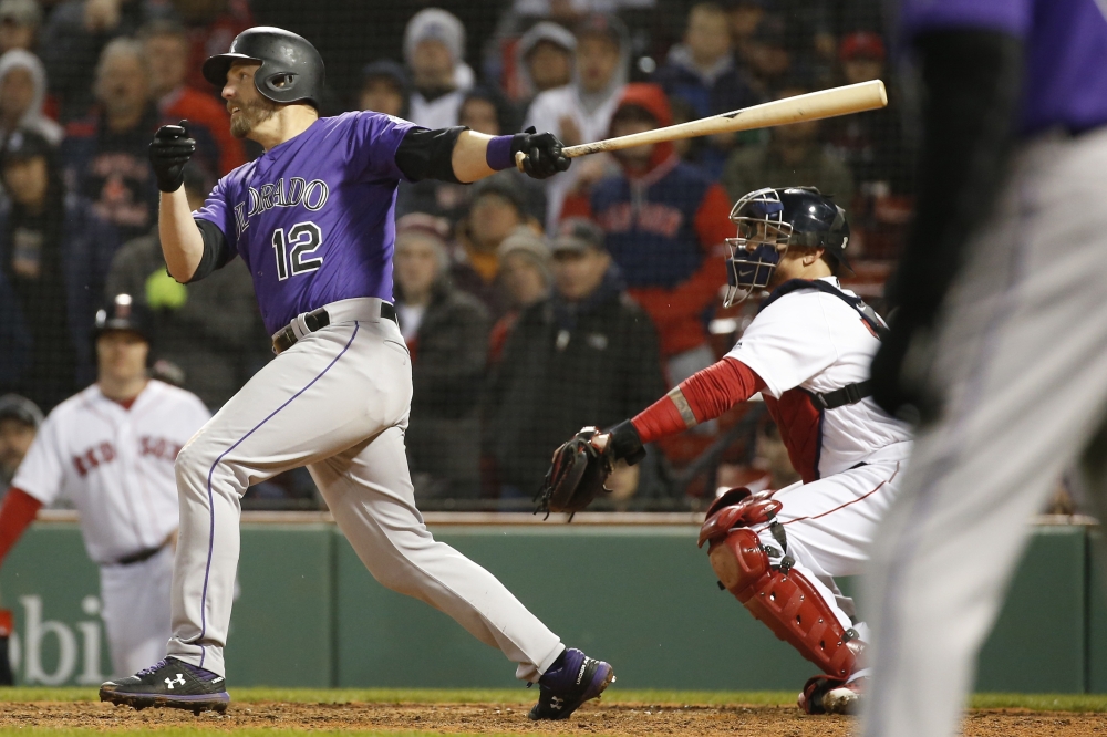 Colorado Rockies first baseman Mark Reynolds (12) hits an RBI single during the eleventh inning against the Boston Red Sox at Fenway Park, in this May 14, 2019 file photo. — Reuters