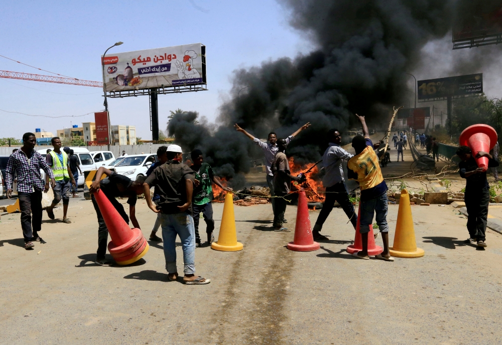 Sudanese protesters burn tires and barricade the road leading to Al-Mek Nimir Bridge crossing over Blue Nile; that links Khartoum North and Khartoum. — Reuters