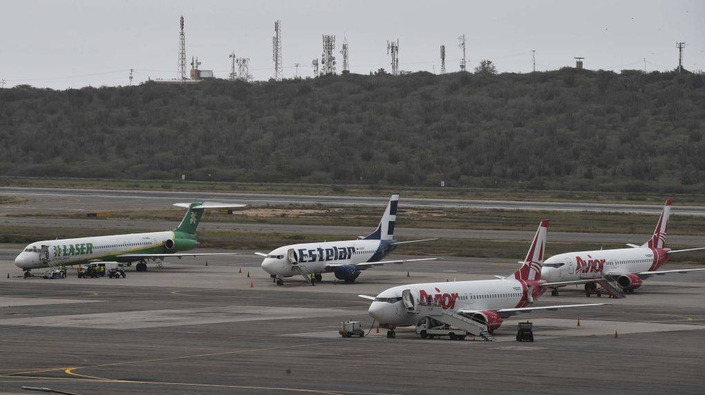 Commercial planes sit on the tarmac at Simon Bolivar International Airport in Maiquetia, northern Venezuela, on March 8, 2019 during the worst power outage in the country's history. — AFP photo