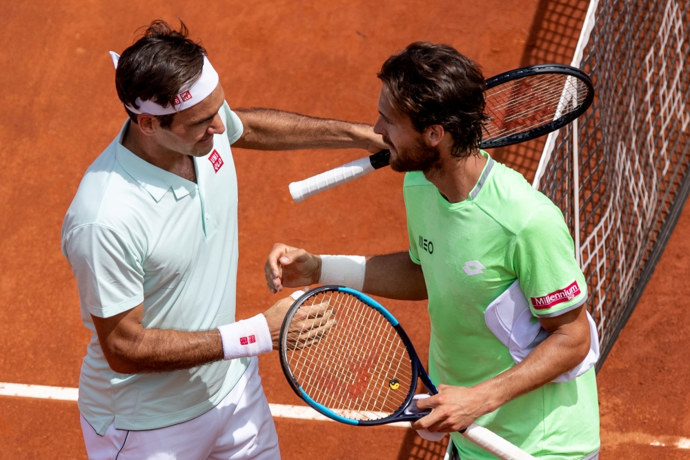 Switzerland's Roger Federer and Portugal's Joao Sousa shake hands after their second round match in the ATP 1000 Italian Open at the Foro Italico, Rome, Italy, on Thursday. — Reuters