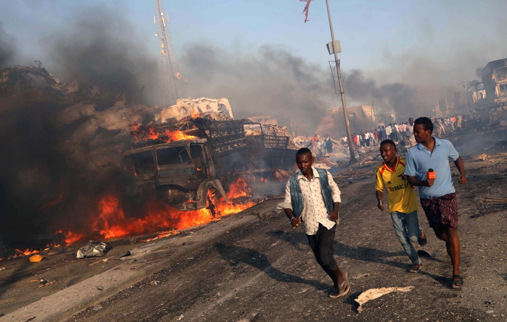 Civilians leave the scene of an explosion in KM4 street in the Hodan district of Mogadishu on October 14, 2017. — Reuters file photo