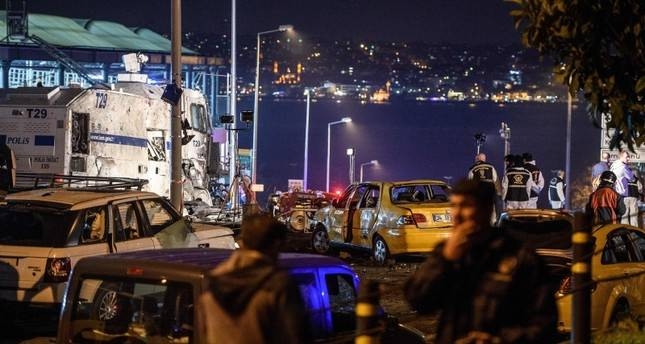 Turkish police officers and forensic work next to damaged police vehicles and cars on the site where a car bomb exploded near the stadium of football club Beşiktaş in central Istanbul on Dec. 10, 2016. (AFP file photo)