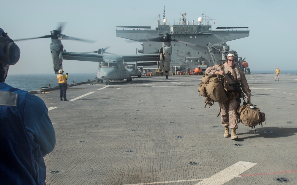 US Marine Corps Gunnery Sgt. David Arendt carries his gear across the flight deck of the USS Lewis B. Puller upon embarkation in the Arabian Gulf in this May 11, 2019 file photo. — Reuters