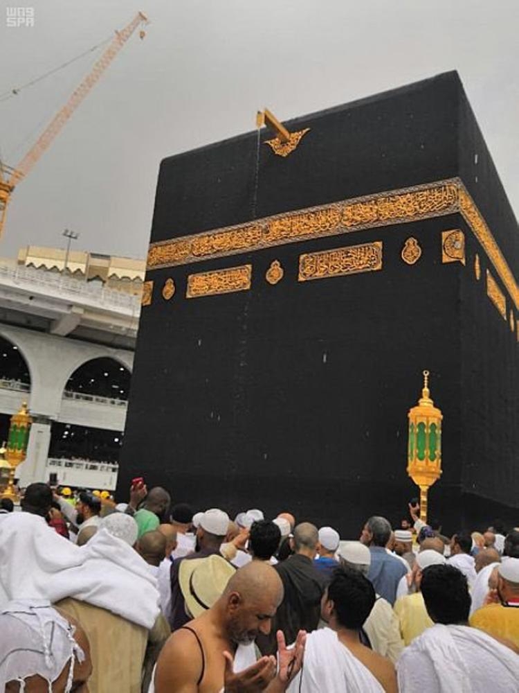 Pilgrims and visitors enjoy welcome showers that blessed the holy city of Makkah on Saturday. — SPA