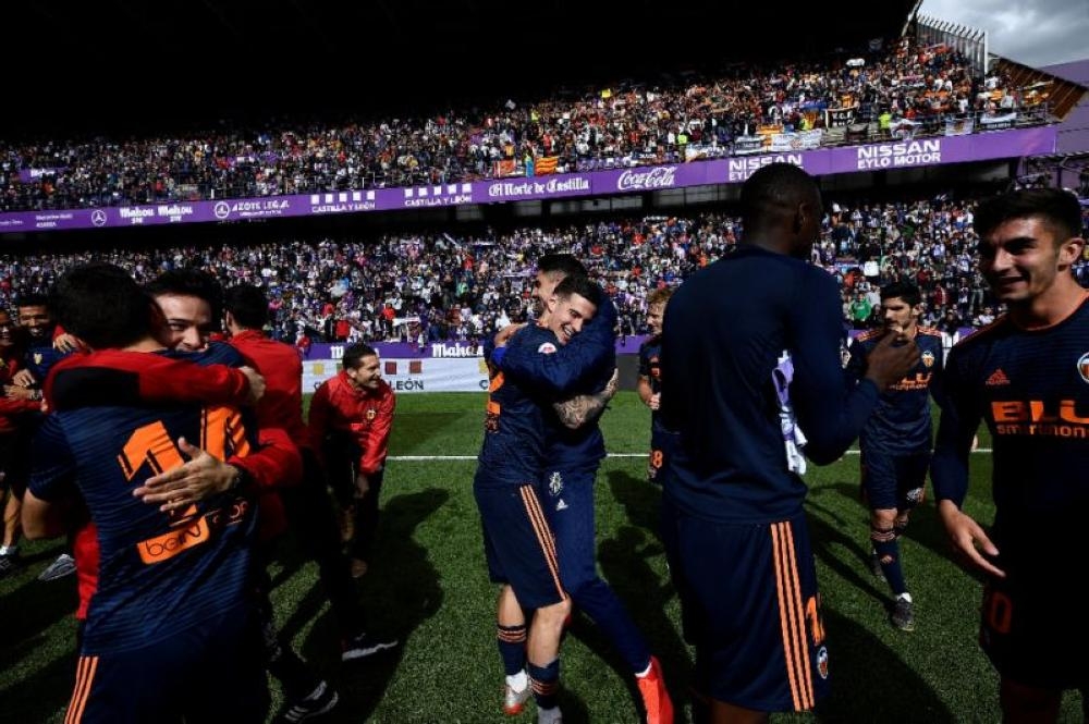 Valencia’s players celebrate qualifying for next season’s Champions League. — AFP 