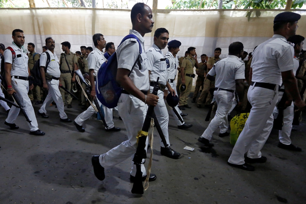 Police officers are pictured at a center distributing election materials ahead of the seventh and last phase of general election, in Kolkata, India, May 19. - Reuters