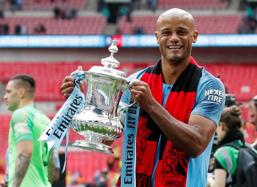 Manchester City's Vincent Kompany celebrates with the trophy after winning the FA Cup at the Wembley Stadium, London, in this May 18, 2019 file photo. — Reuters