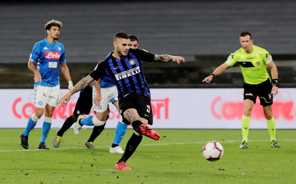 Inter Milan’s Mauro Icardi scores their first goal from the penalty spot in Naples, Italy, on Sunday. — Reuters