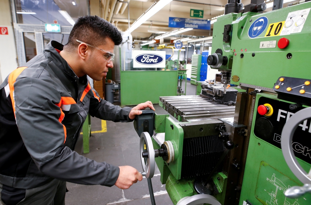 Qudratullah Hotak, a 25-year-old refugee from Afghanistan and one of 24 trainees of Ford Germany's so-called Equipment Qualification (EQ) program to integrate migrants in a booming labor market, adjusts a machine at the training workshop of Ford Motor Co in Cologne, Germany, in this Jan. 11, 2019 file photo. — Reuters