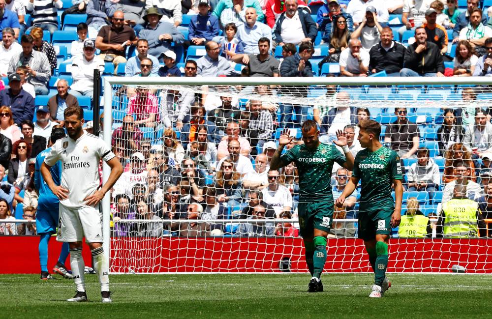 Real Betis' Jese celebrates scoring their second goal with Loren Moron as Real Madrid's Nacho looks dejected during the La Liga tie at the Santiago Bernabeu, Madrid, Spain, on Sunday. — Reuters