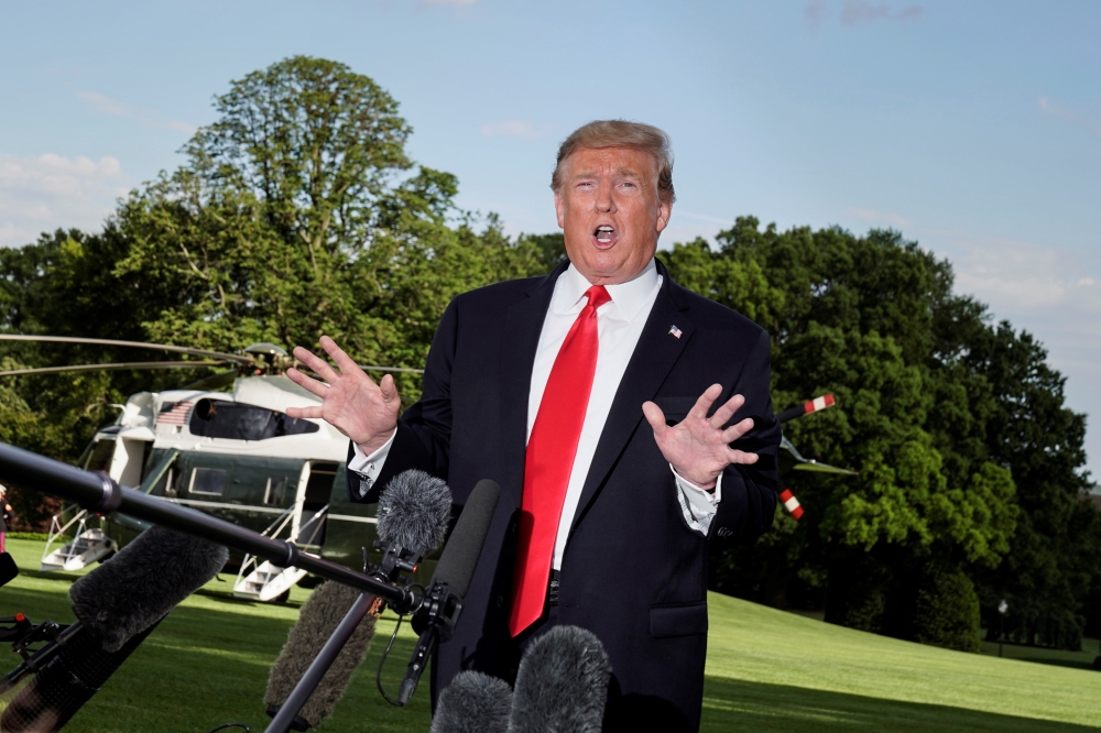 US President Donald Trump speaks to the media as he departs for a campaign rally from the White House in Washington on Monday. — Reuters