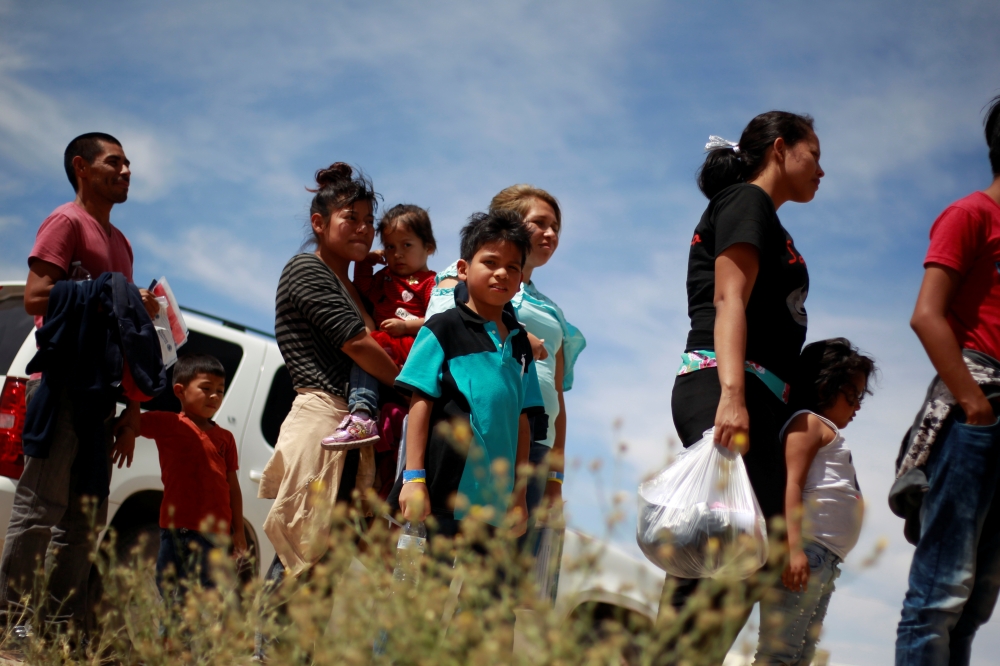 Central American migrants stand in line before entering a temporary shelter, after illegally crossing the border between Mexico and the US, in Deming, New Mexico, May 16. - Reuters