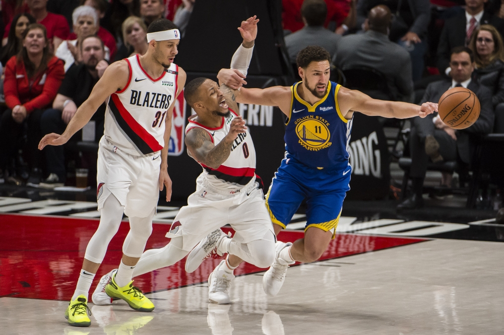 Golden State Warriors guard Klay Thompson (11) is called for a foul against Portland Trail Blazers guard Damian Lillard (0) during the second half in game four of the Western conference finals of the 2019 NBA Playoffs at Moda Center. The Warriors won 119-117 in overtime. — Reuters
