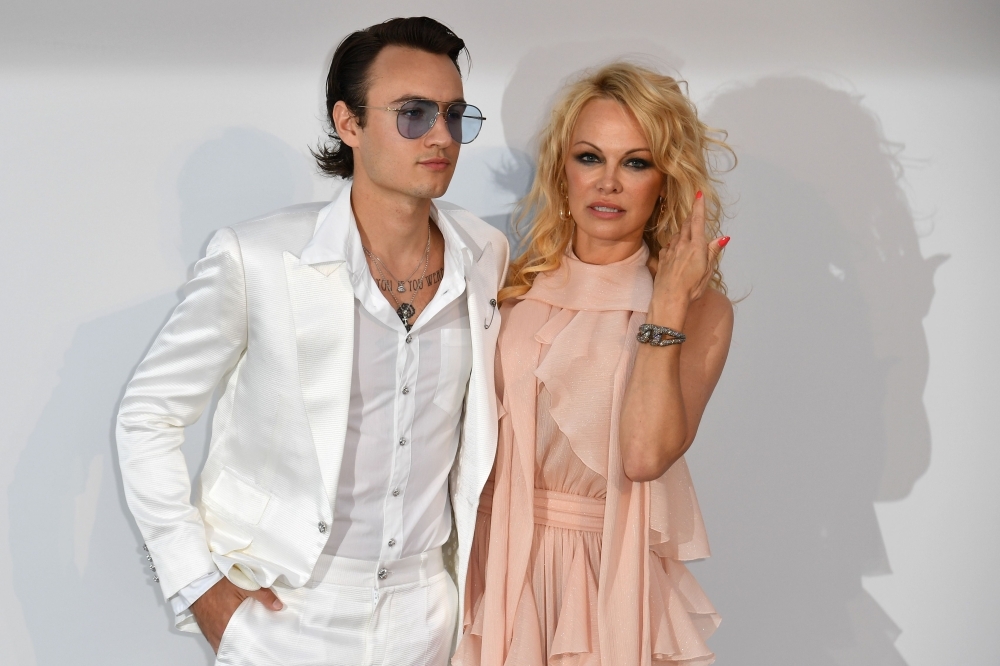 US actress Pamela Anderson, right, and her son Brandon Thomas Lee pose as they arrive on Thursday for the amfAR 26th Annual Cinema Against AIDS gala at the Hotel du Cap-Eden-Roc in Cap d'Antibes, southern France, on the sidelines of the 72nd Cannes Film Festival. — AFP