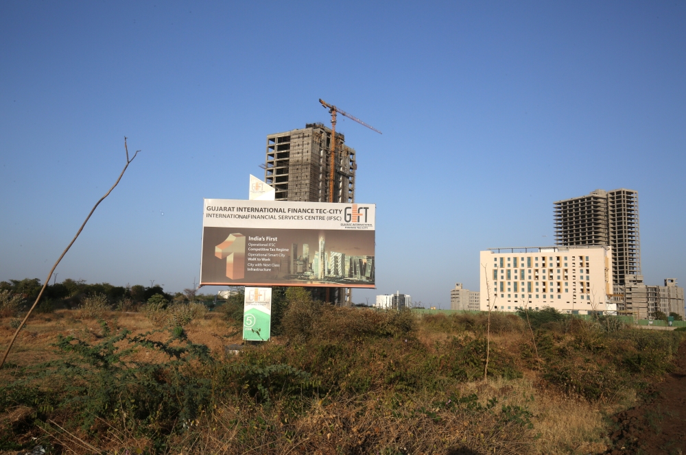 A billboard stands in front of buildings under construction at the Gujarat International Finance Tec-City (GIFT) at Gandhinagar, in the western state of Gujarat, in this file photo. — Reuters
