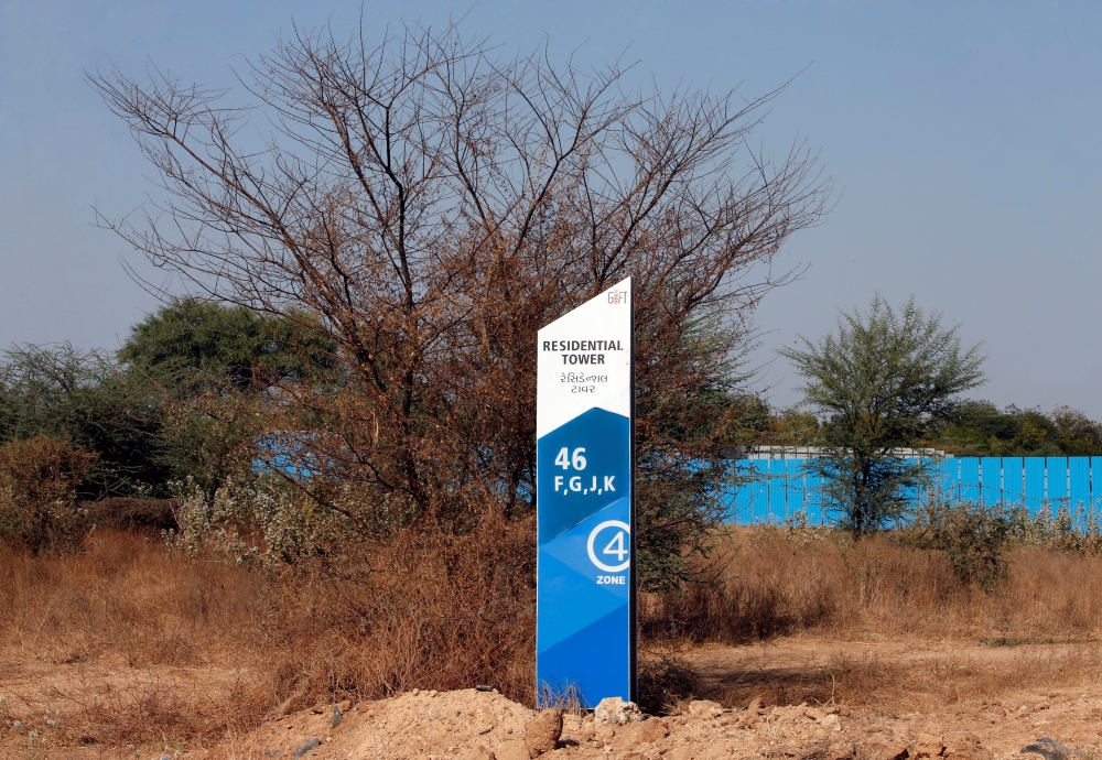 A billboard stands in front of buildings under construction at the Gujarat International Finance Tec-City (GIFT) at Gandhinagar, in the western state of Gujarat, in this file photo. — Reuters