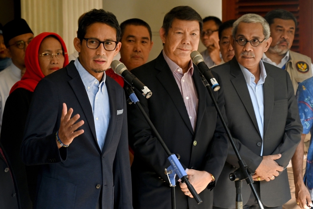 Sandiaga Uno (L), the running mate of presidential challenger Prabowo Subianto, gestures to the media as he announces on May 24 that his team will file an appeal over claims of widespread cheating in last month's election to Indonesia's Constitutional Court in Jakarta. — AFP