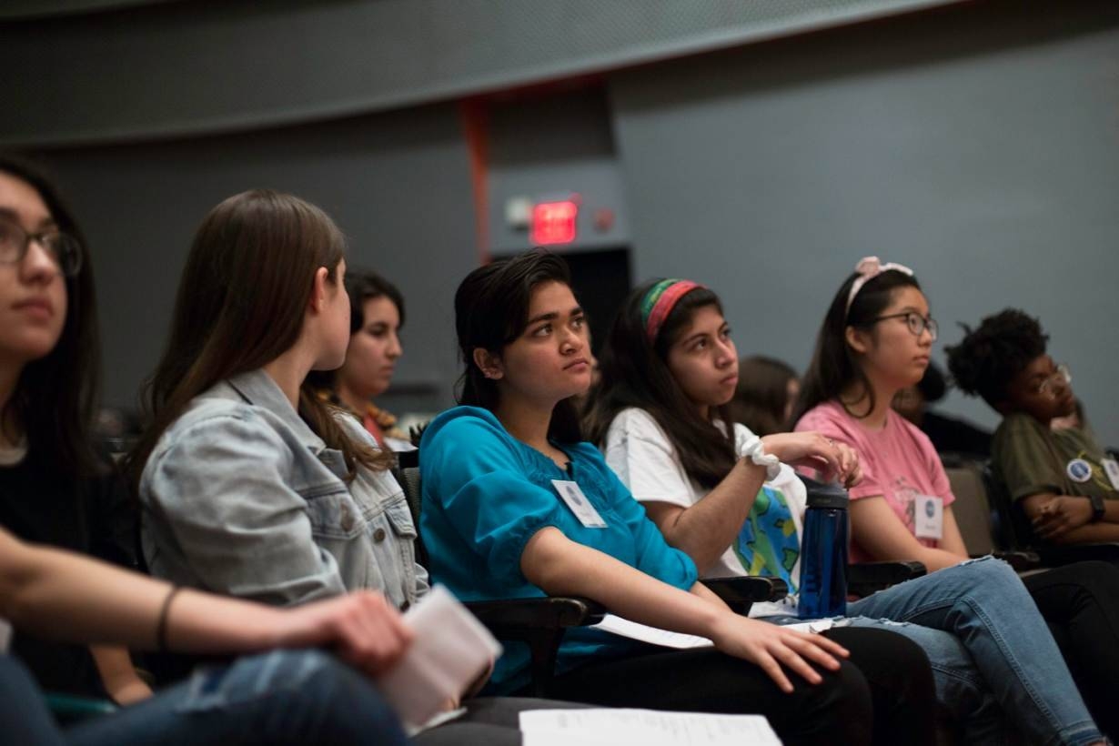 High school student poets listen to a poem about climate change in the New School auditorium as they prepare for final auditions for 