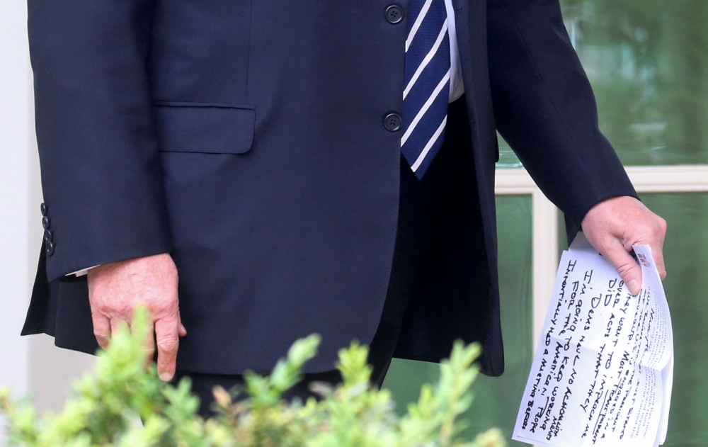 US President Donald Trump carries his own handwritten notes as he walks out of the Oval Office to speak to reporters about the investigations into himself and his administration by Special Counsel Robert Mueller and congressional Democrats in the Rose Garden at the White House in Washington in this May 22, 2019 file photo. — Reuters