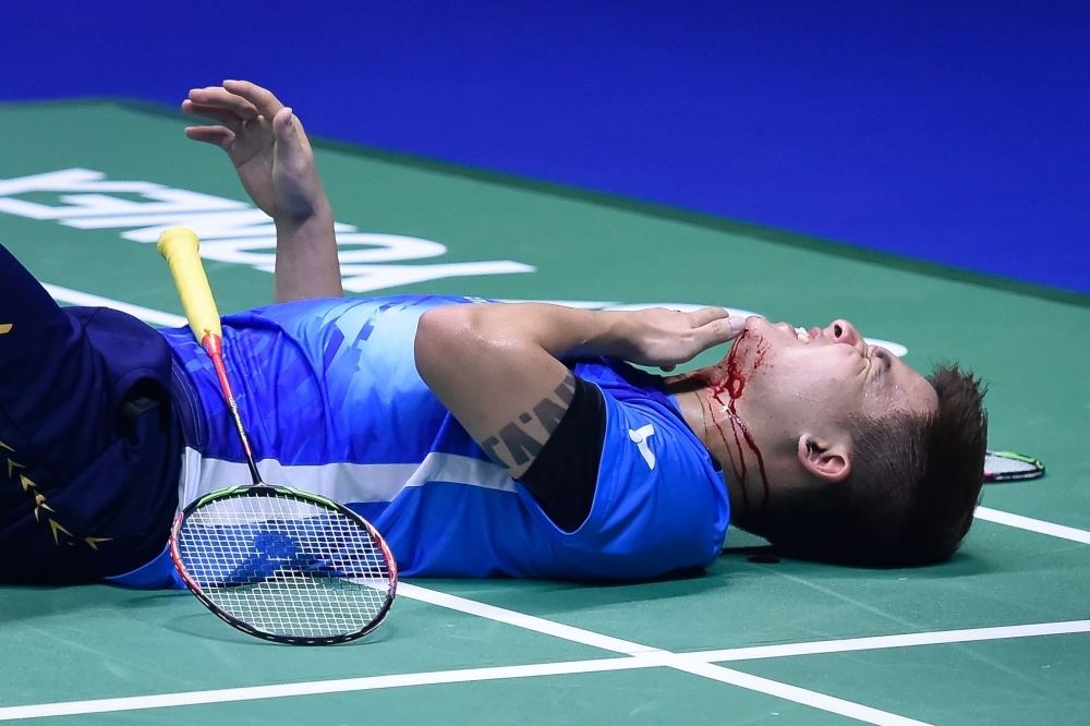 Malaysia's Teo Ee Yi lies injured during their match against Japan's Takeshi Kamura and Keigo Sonoda in their men's doubles quarterfinal match at the 2019 Sudirman Cup world badminton championships in Nanning in China's southern Guangxi region on Friday. — AFP