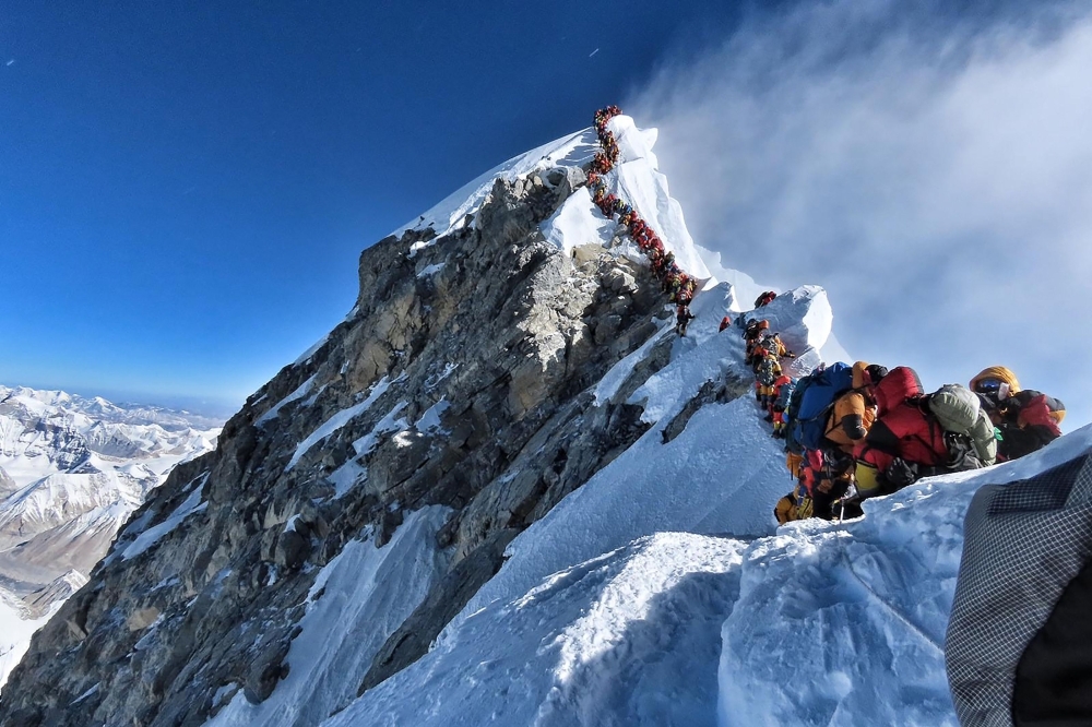 In this file handout photo taken on May 22, 2019 and released by climber Nirmal Purja's Project Possible expedition shows heavy traffic of mountain climbers lining up to stand at the summit of Mount Everest. — AFP