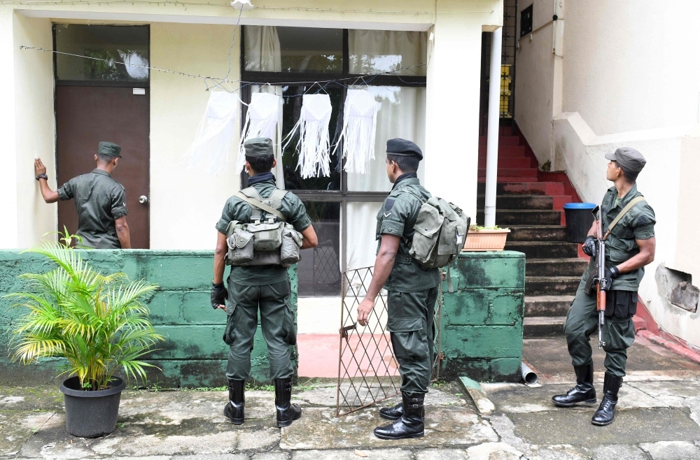 Sri Lankan soldiers inspect a house during special cordon-and-search operations in Colombo on Saturday. Sri Lanka's military launched a major hunt for remnants of a militant group which carried out the Easter suicide bombings that killed 258 people, officials said. — AFP
