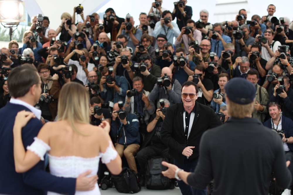 US film director Quentin Tarantino (2nd R) jokes with photographers while posing with US actor Leonardo DiCaprio (L), Australian actress Margot Robbie (2ndL) and US actor Brad Pitt during a photocall for the film 