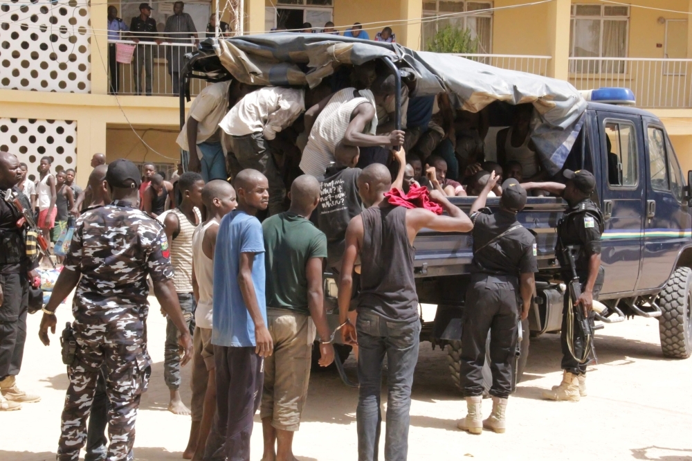 Alleged kidnappers are taken away by the police in Maiduguri after having been paraded in front of confiscated goods such as weapons, medicines, phones and other items in this May, 23, 2019 file photo. — AFP