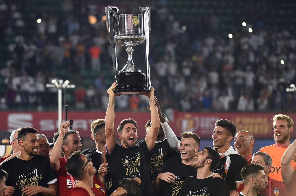 Valencia players celebrate with their trophy after winning the 2019 Spanish Copa del Rey (King's Cup) final football match between Barcelona and Valencia at the Benito Villamarin stadium in Sevilla on Saturday. — AFP