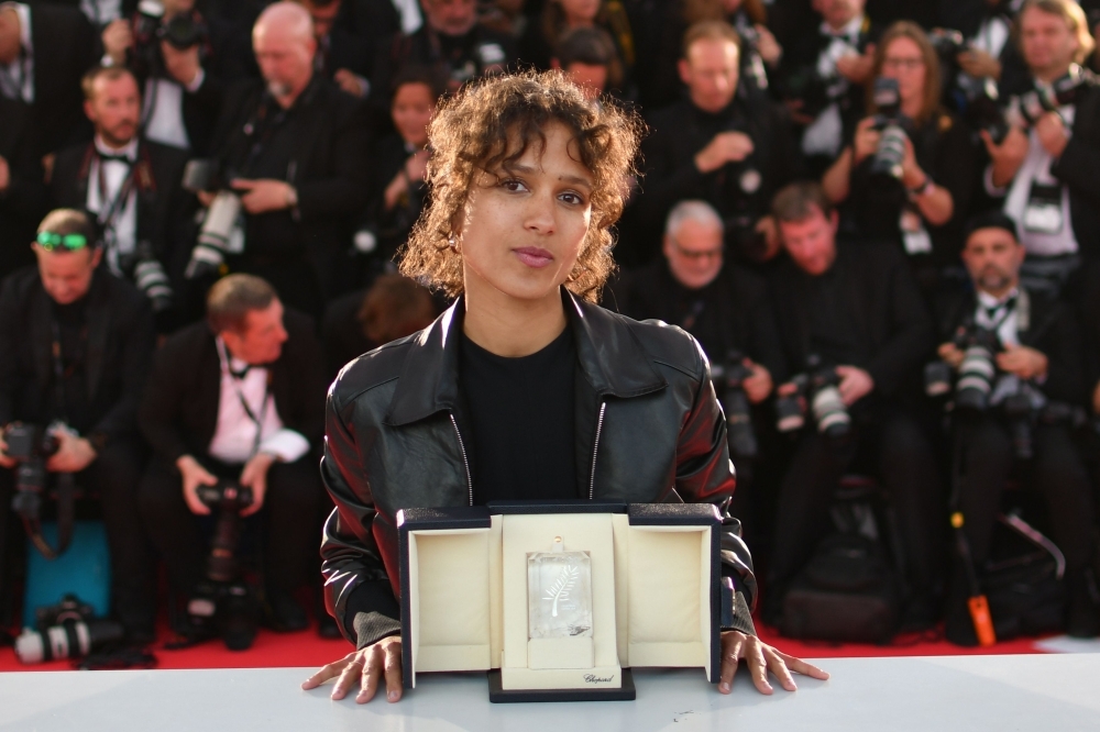French actress and film director Mati Diop poses during a photo-call with her trophy after she won the Grand Prix for her film 