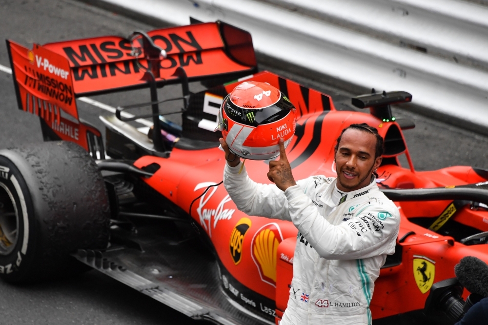 Mercedes' British driver Lewis Hamilton points at the name of late Formula One legend Niki Lauda on his helmet after winning the Monaco Formula 1 Grand Prix at the Monaco street circuit in Monaco on Sunday. — AFP