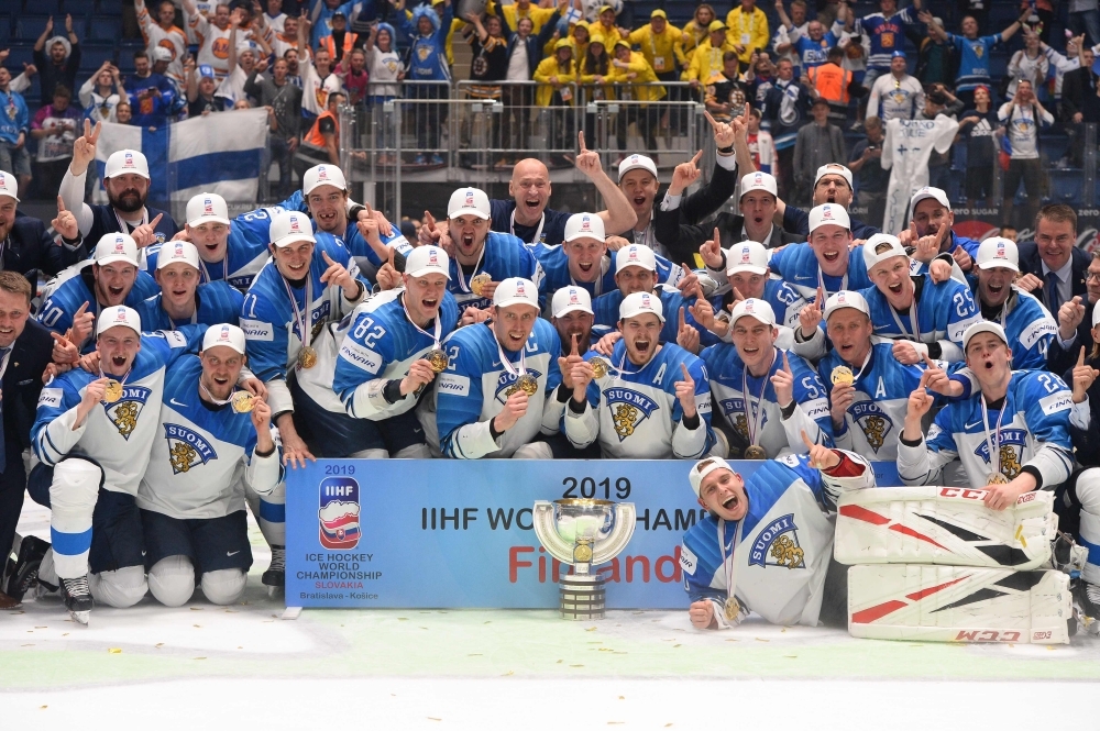 Finland's players celebrate with the trophy after the IIHF Men's Ice Hockey World Championships final between Canada and Finland in Bratislava, Slovakia, on Sunday. — AFP