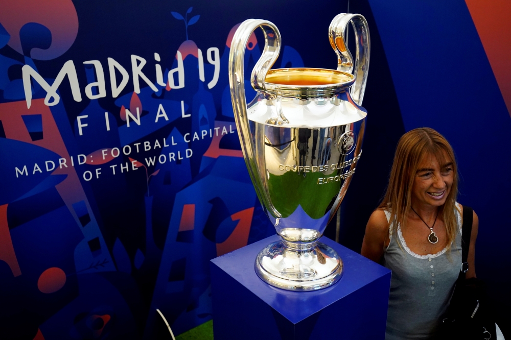 A woman poses with the Champions League trophy in Madrid, Spain, Monday. — Reuters