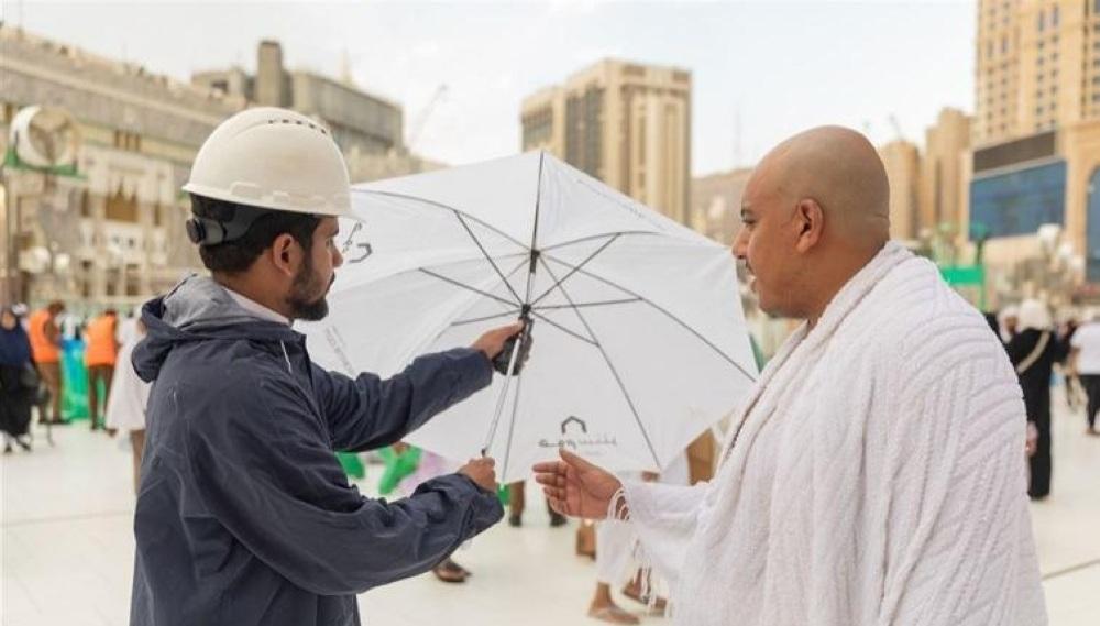 Pilgrim care, the Saudi authorities distributing umbrellas to pilgrims in the Grand Mosque in Makkah to keep them protected from the scorching sun. — SPA